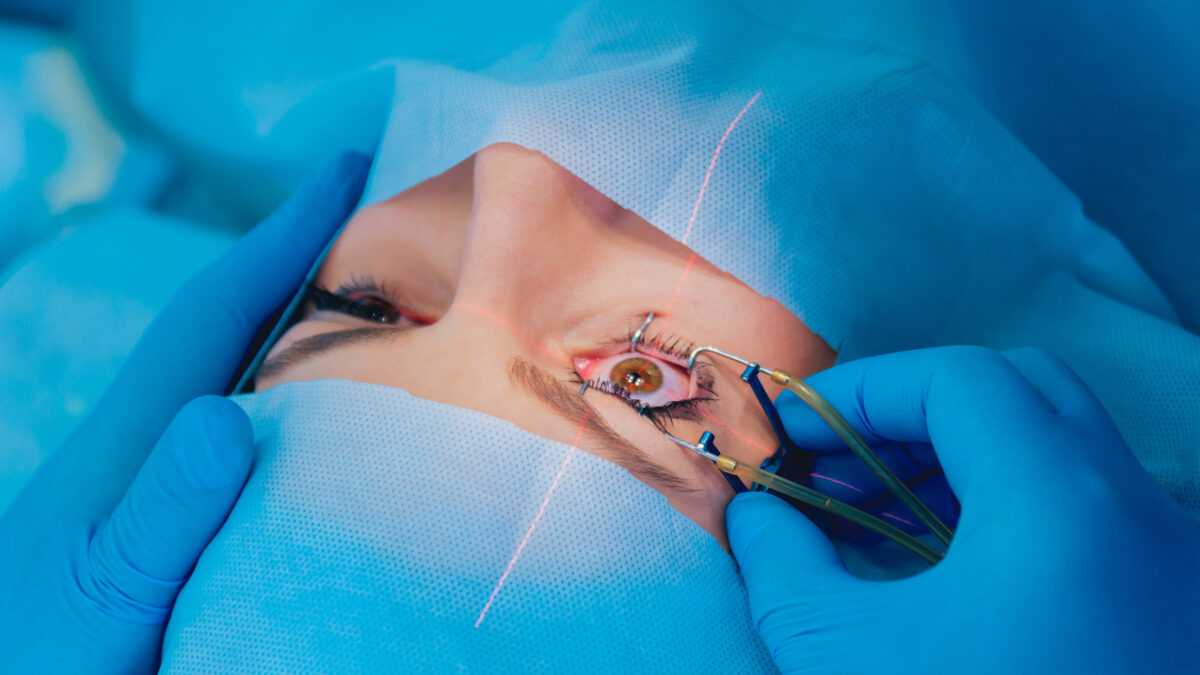 Laser vision correction. A patient and team of surgeons in the operating room